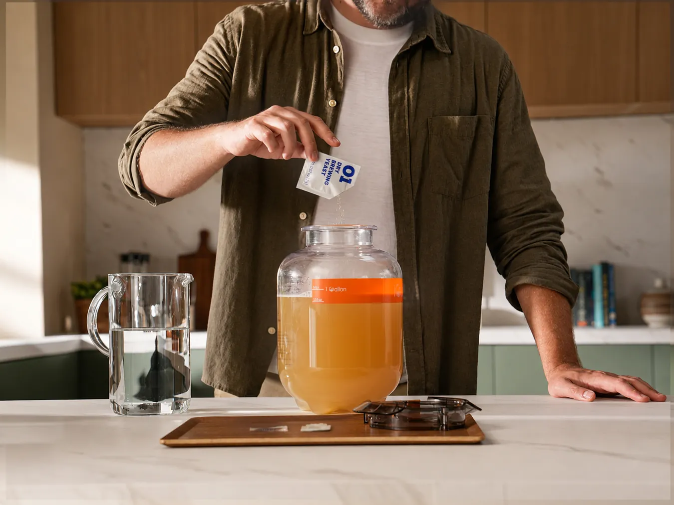 A person preparing a fermented drink beside an iGulu F2 brewer