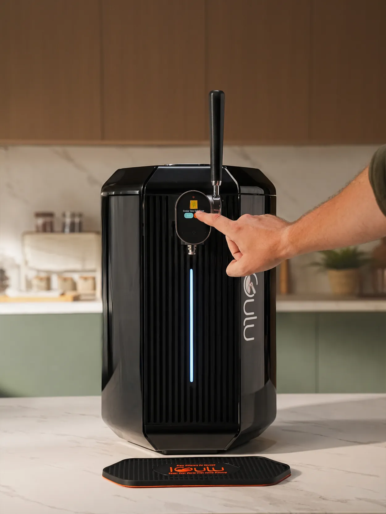 Hand operating the controls on a black iGulu F2 home brewer