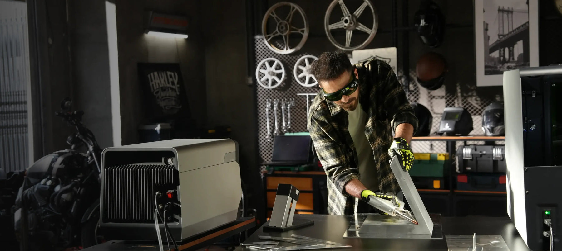 Metalworker using the LaserCyber L1 laser tool at a workshop bench