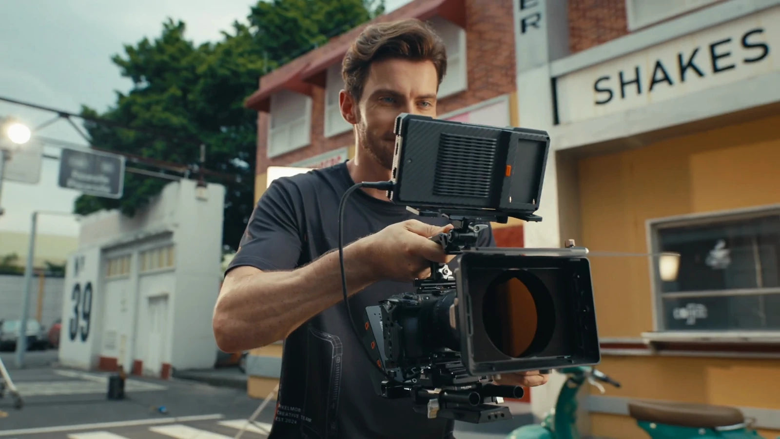 A filmmaker with PixelMob mounted above a camera rig on a street set