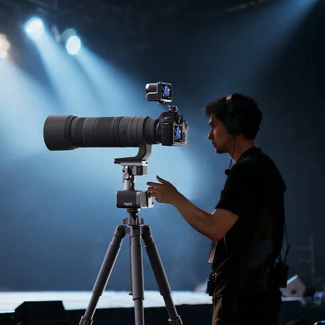 Photographer using a RocXZoom Pro tracking gimbal with a telephoto camera at an event